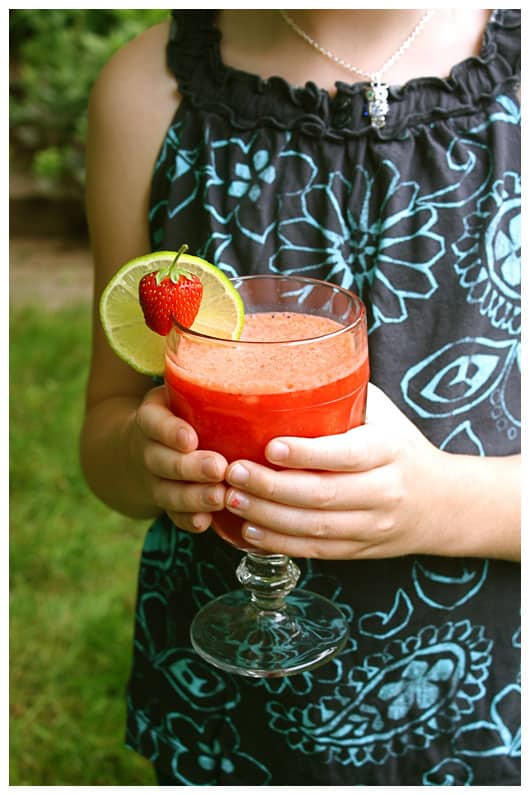 a girl holding a strawberry beverage