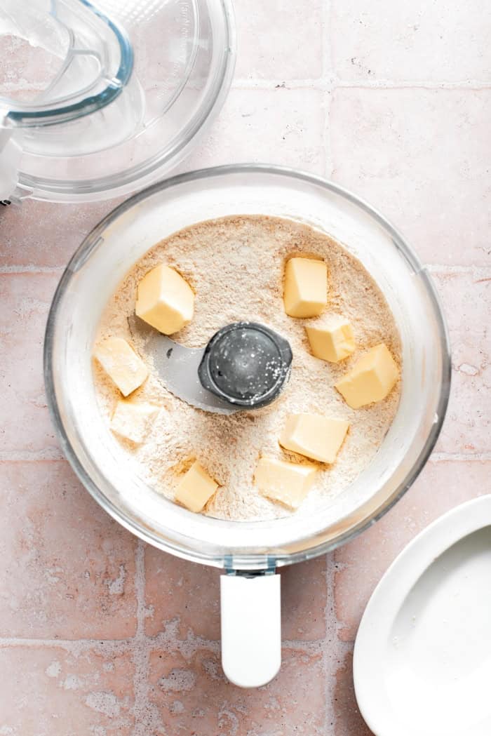 Butter added to dry ingredients in food processor.