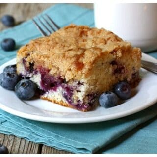a slice of blueberry cake on a white plate