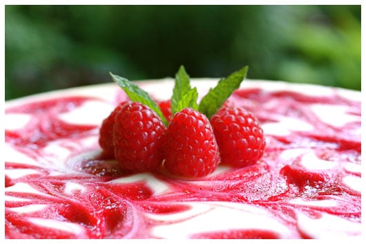 raspberries on top of a cheesecake