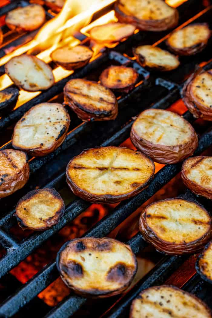 Red potato slices on grill grates