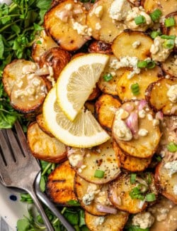 Overhead view of grilled potato salad on platter with two forks