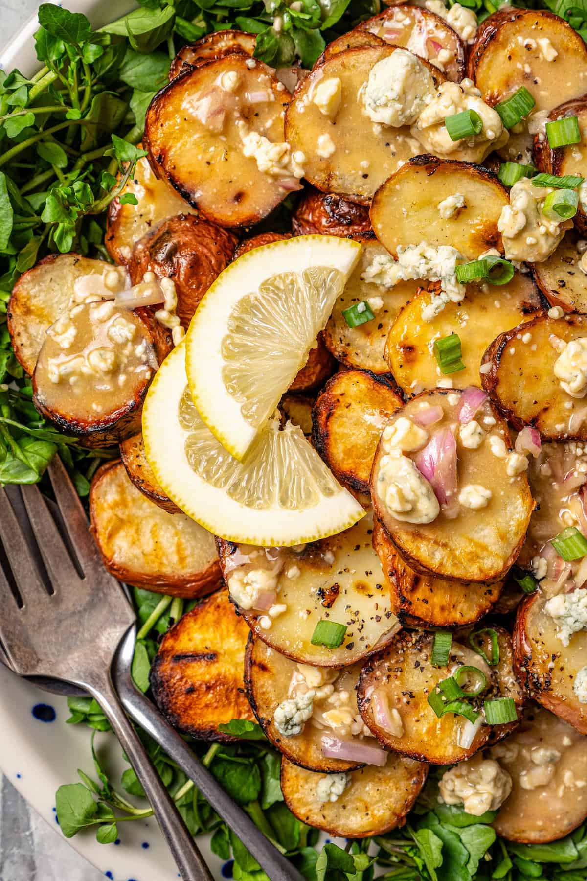 Overhead view of grilled potato salad on platter with two forks