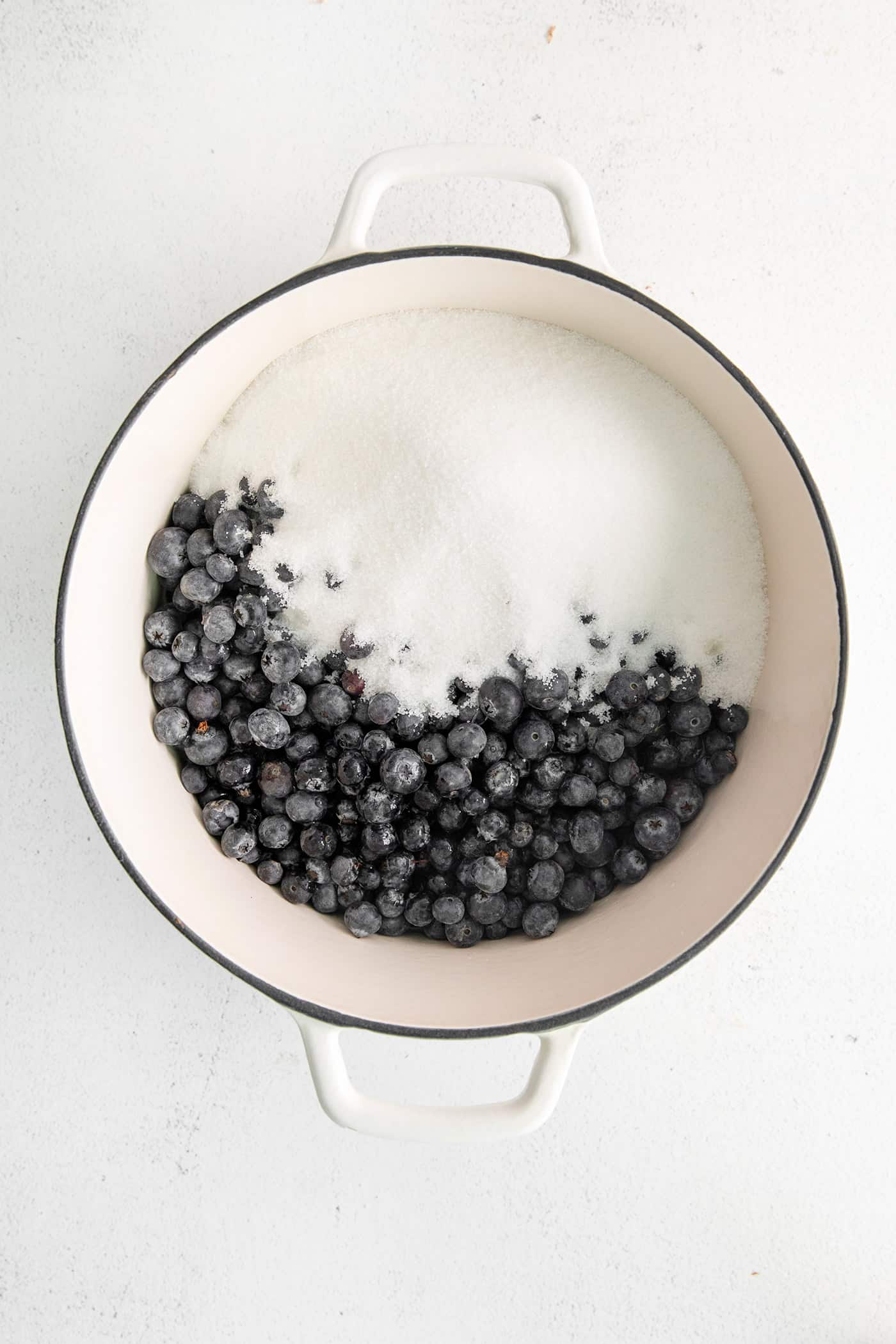 Blueberries and sugar in a pot