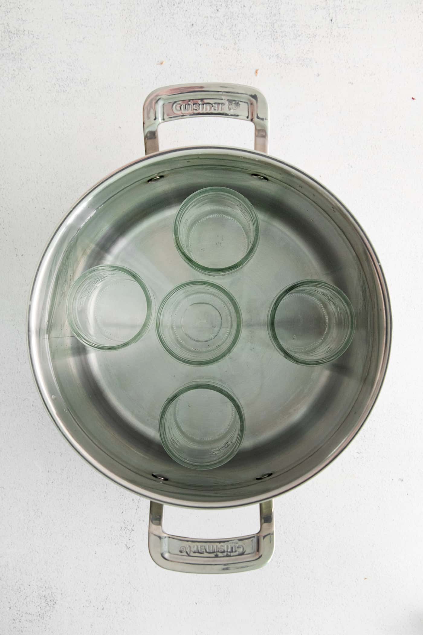 Canning jars in a stock pan with water