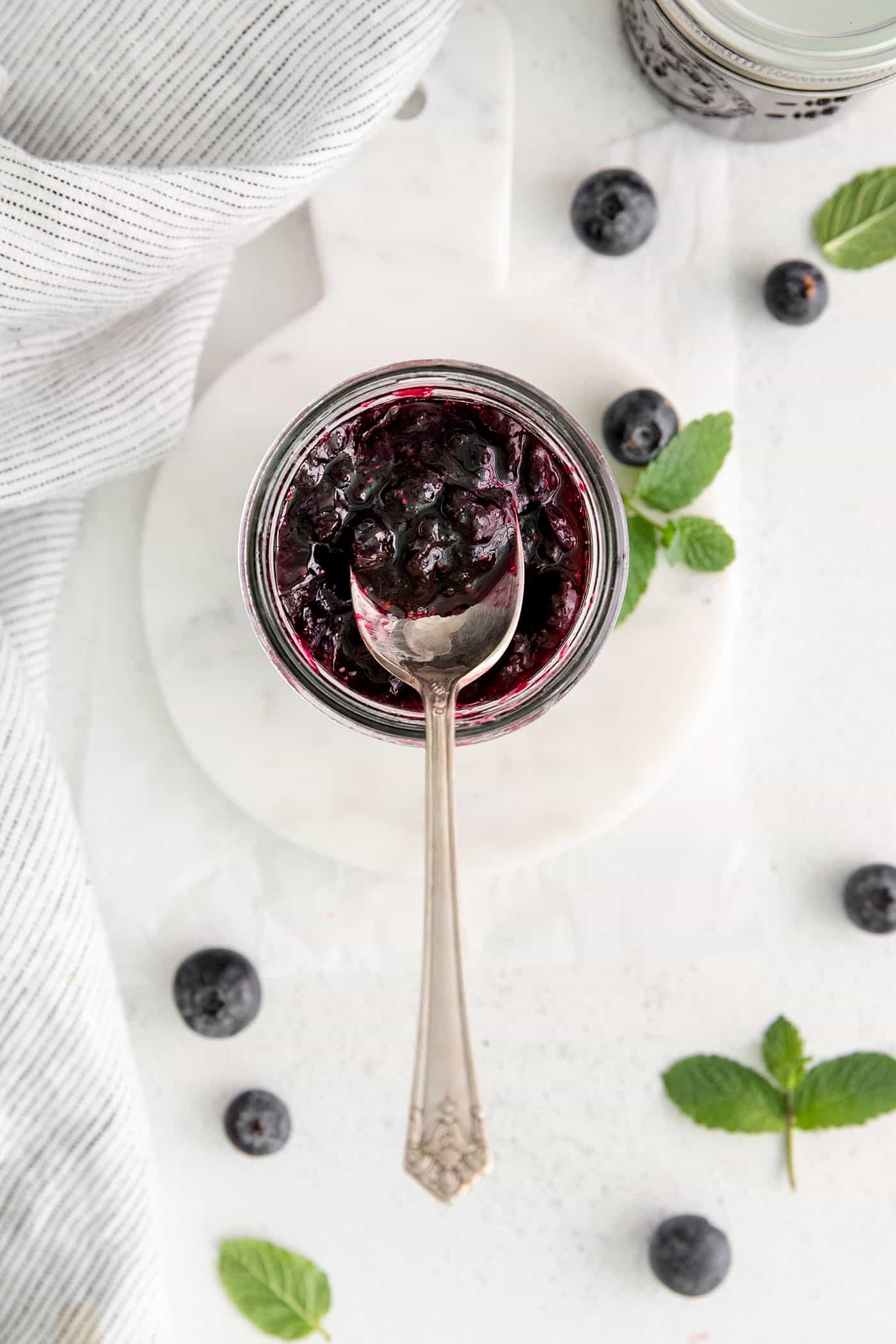 Overhead view of a spoon in a jar of jam