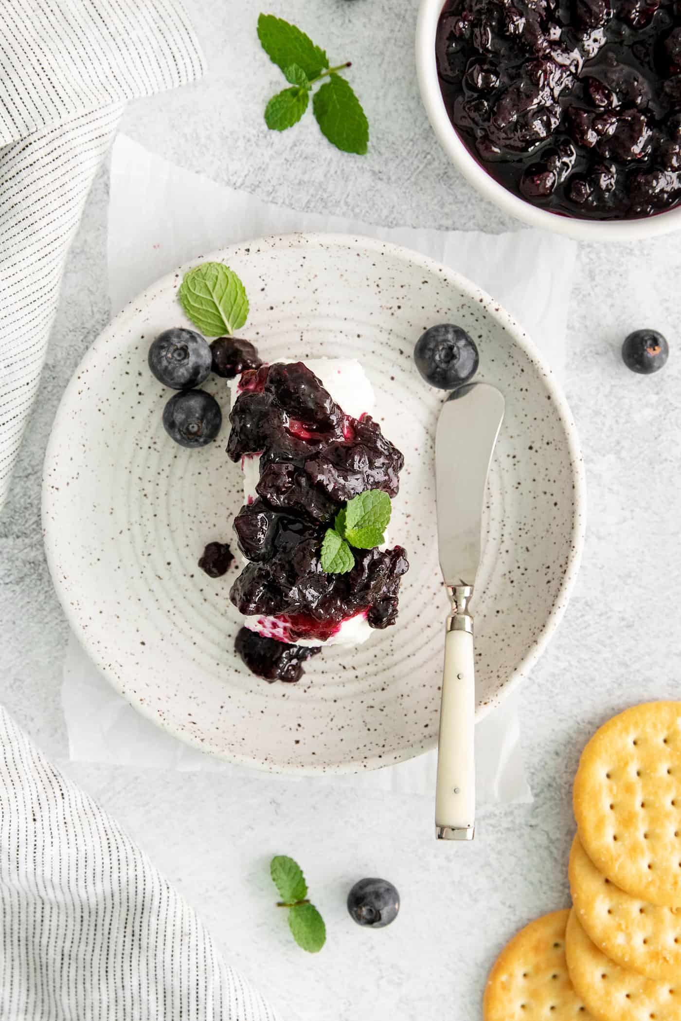 Overhead view of ice cream topped with blueberry jam