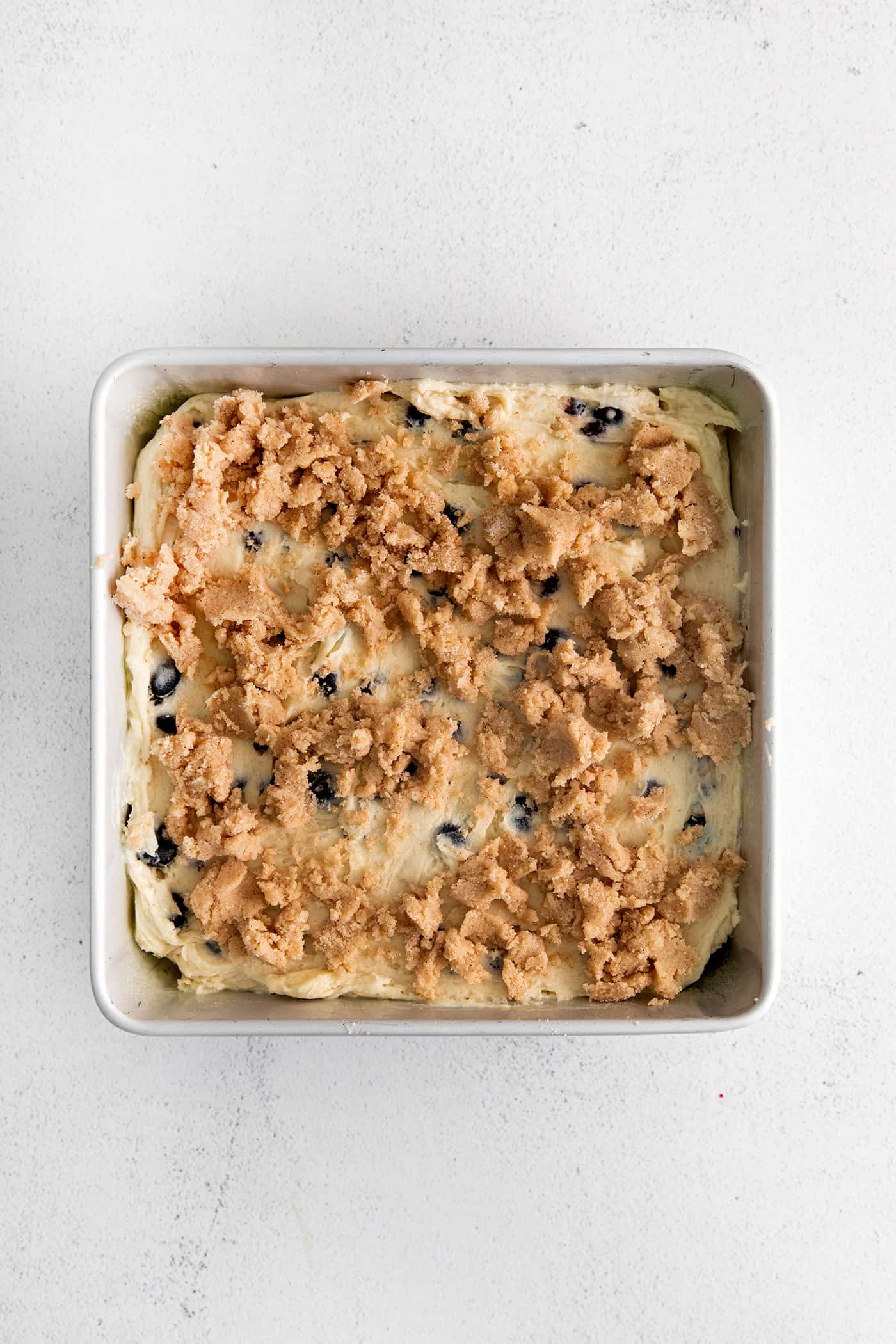 Crumb topping on top of blueberry cake batter