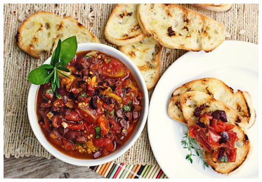 pieces of toast with a bowl of tapenade