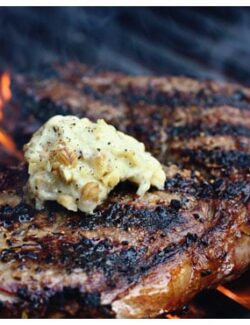 a steak on a grill with butter
