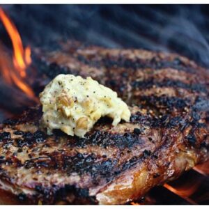 a steak on a grill with butter