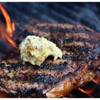 a steak on a grill with butter