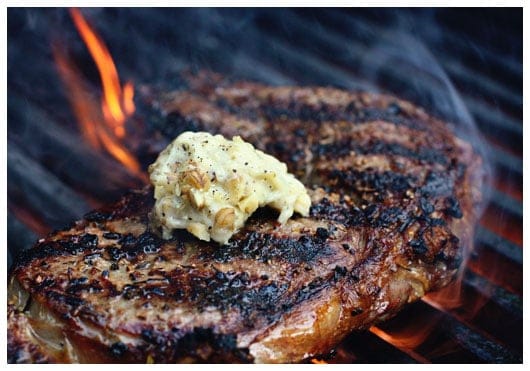 a steak on a grill with butter