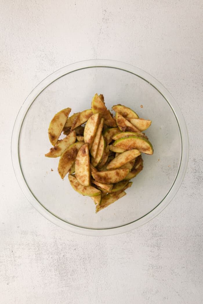 Apples tossed in cinnamon in a bowl