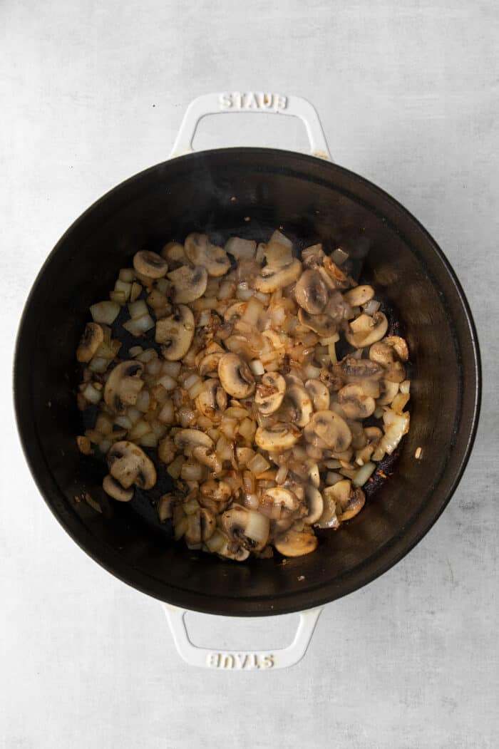 Cooked ground beef and mushrooms in a pot