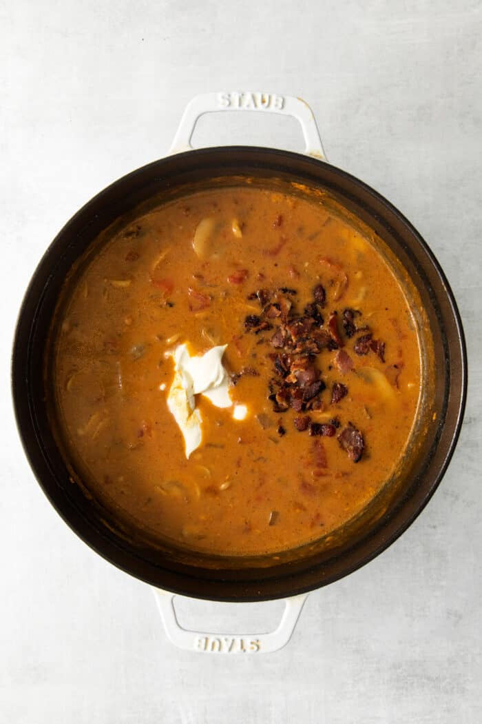 Cheeseburger soup ingredients in a pot