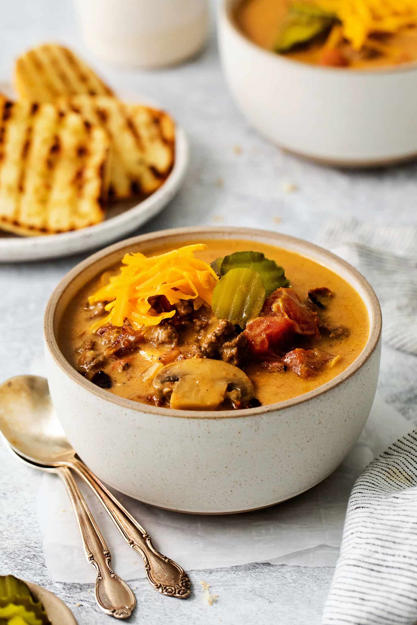 An angled view of a bowl of cheeseburger soup