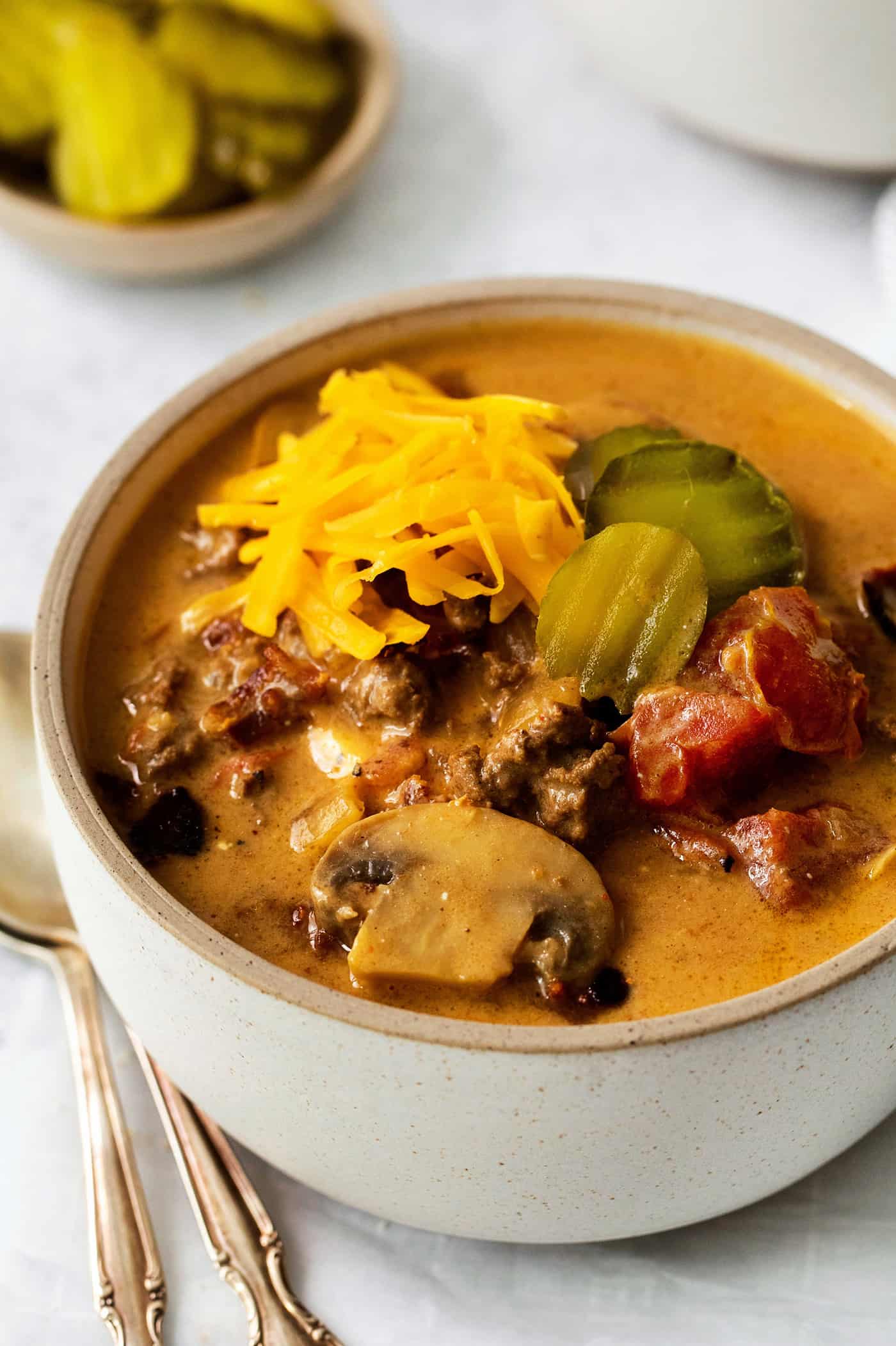 Angled view of a bowl of bacon mushroom cheeseburger soup