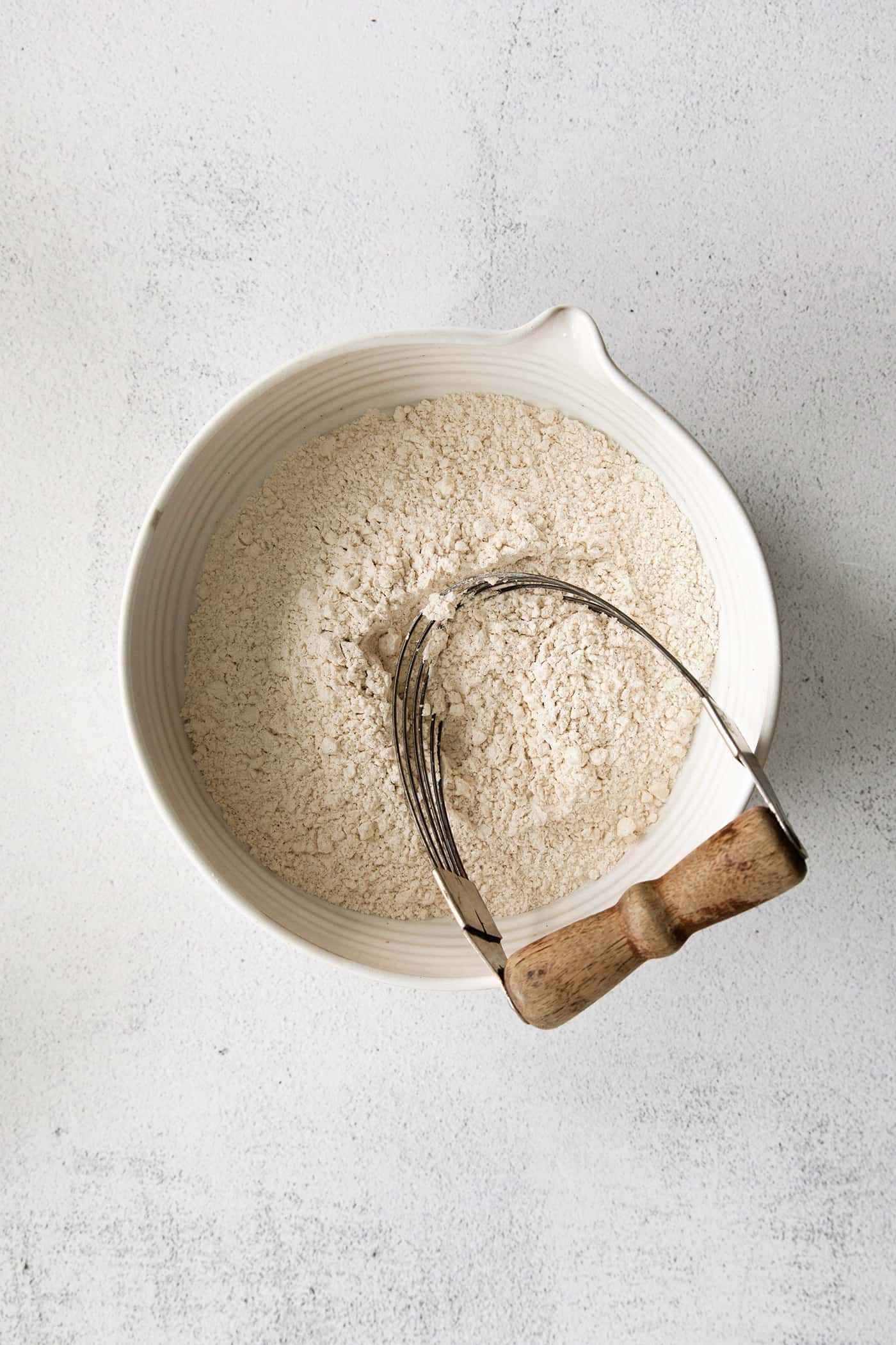 Butter being cut into dry ingredients