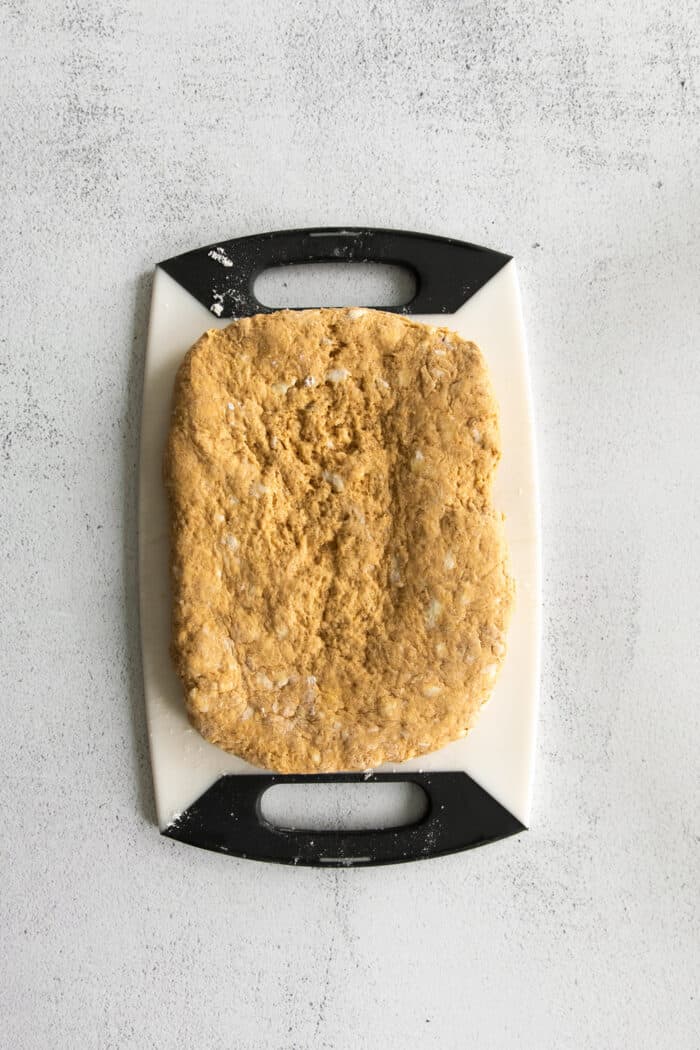 Pumpkin biscuit dough rolled into a rectangle