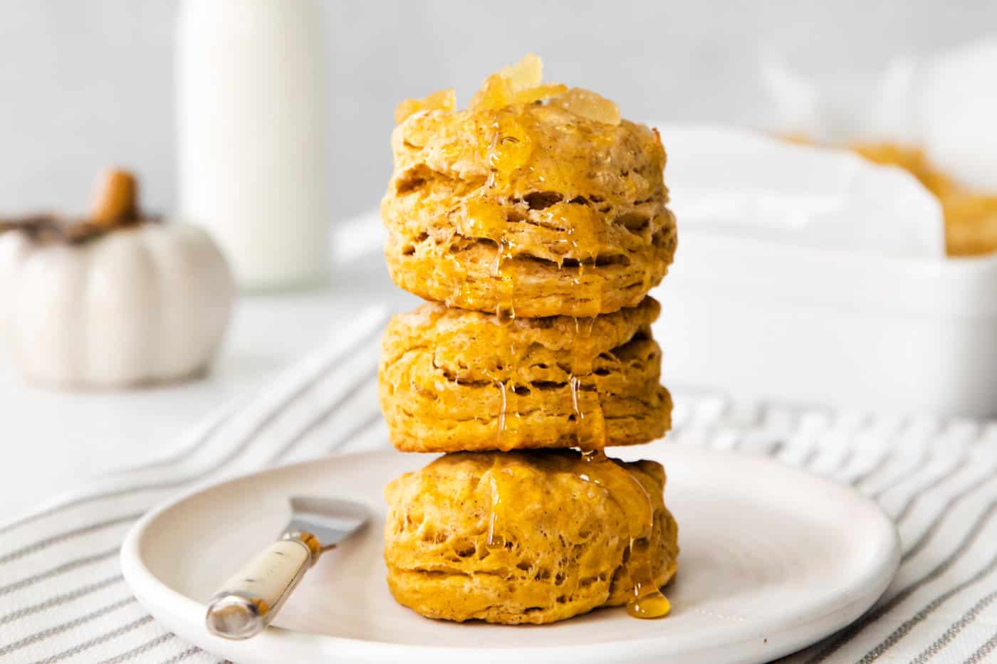 Four biscuits stacked on a white plate