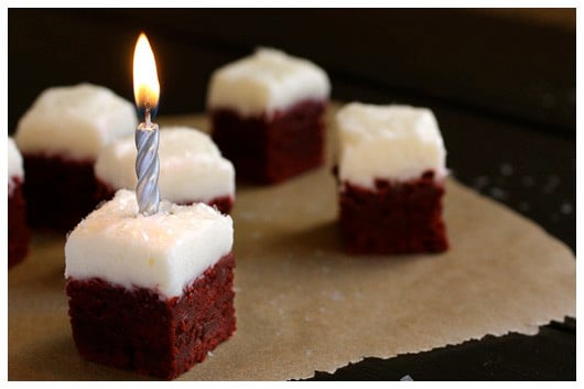 a brownie bite with a lit candle on top