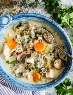 Overhead view of cream chicken and wild rice soup in a blue bowl.