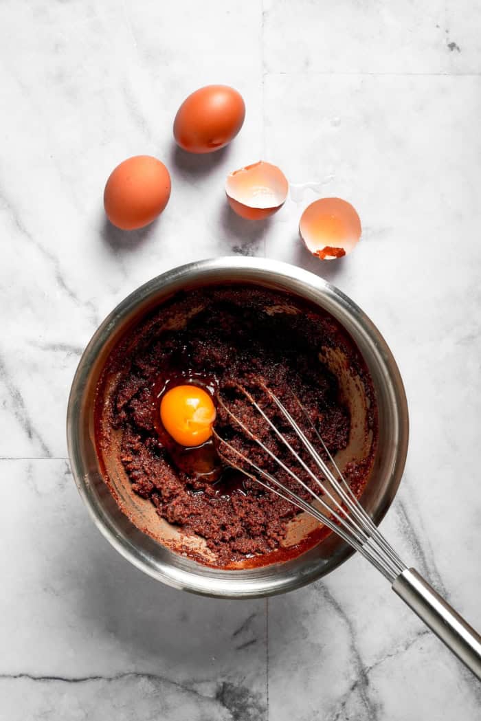 Whisking eggs into brownie batter