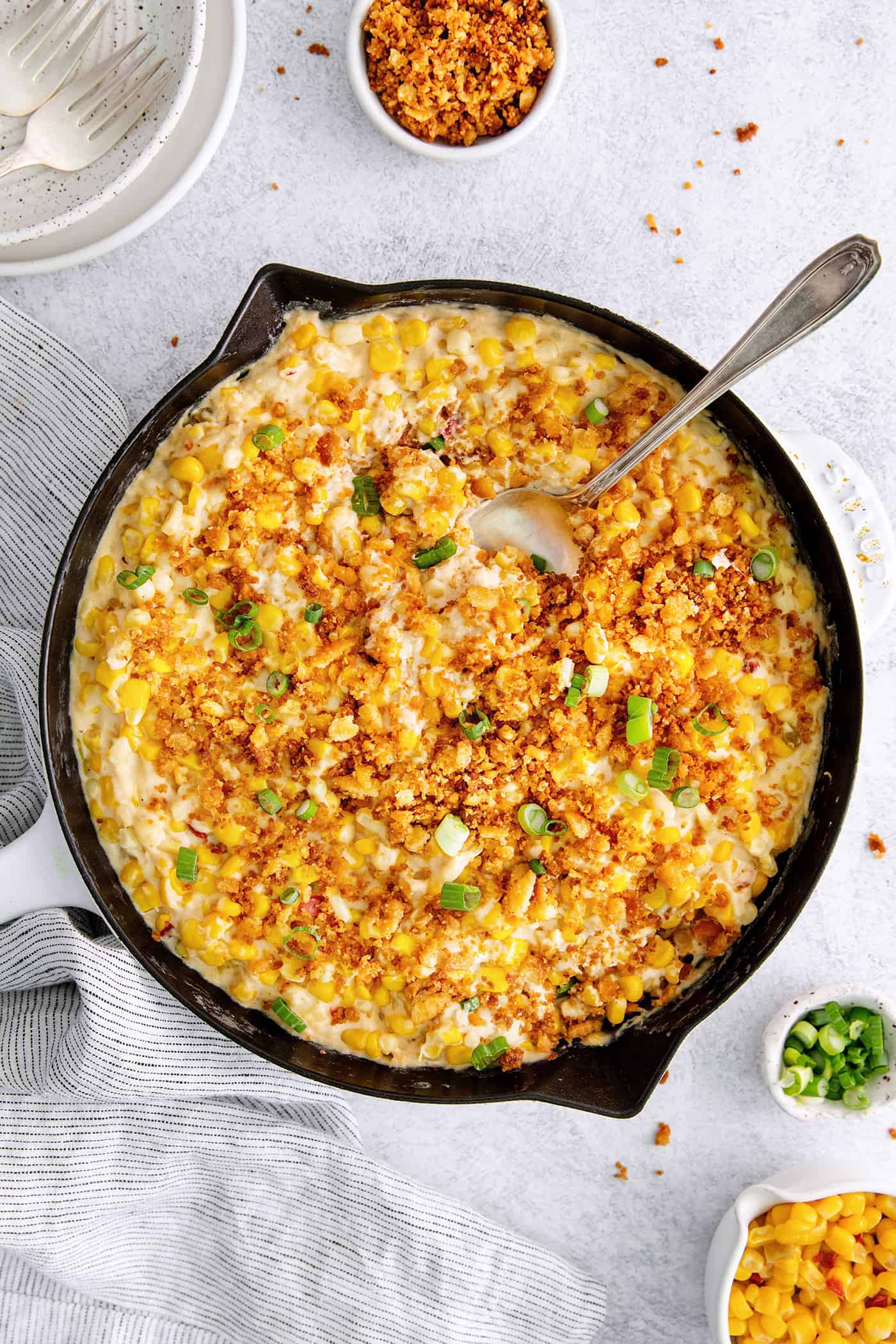 With 3 types of corn and a creamy Swiss cheese sauce, this Cheesy Skillet Scalloped Corn is a family favorite side dish! Overhead view of cheesy skillet scalloped corn