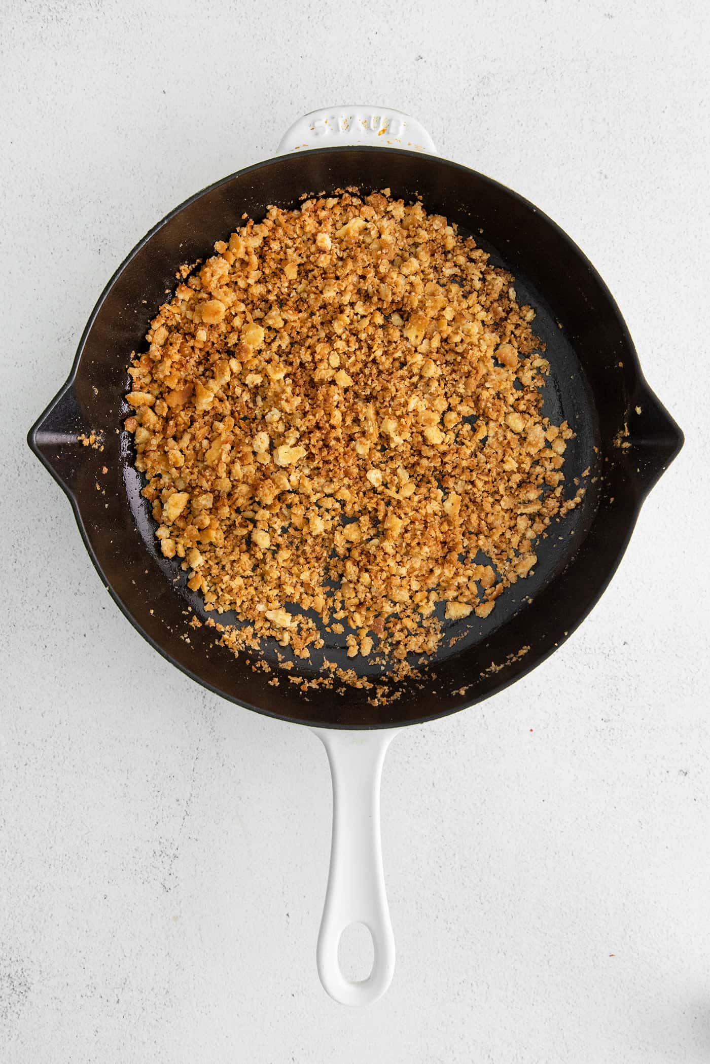 Ritz crumbs and butter in a cast iron skillet