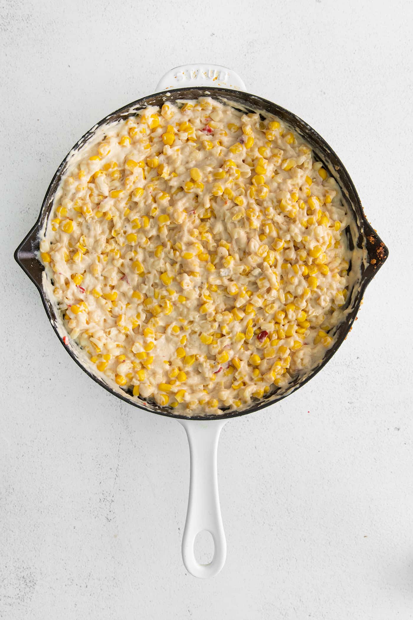 Cheesy skillet corn in a cast iron skillet