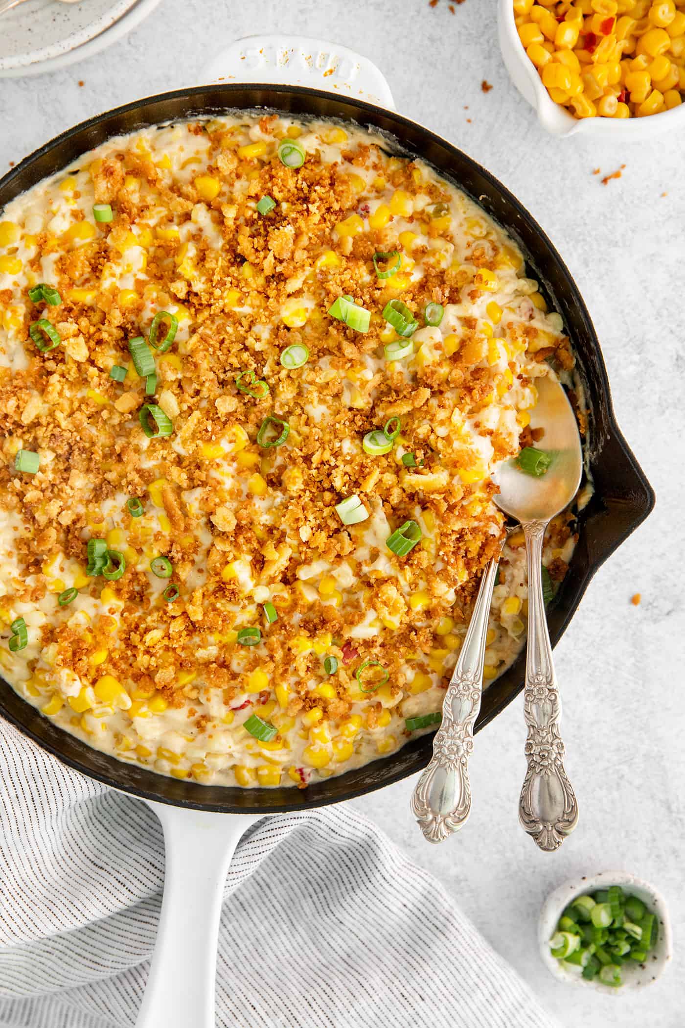 Overhead view of cheesy skillet scalloped with with a spoon