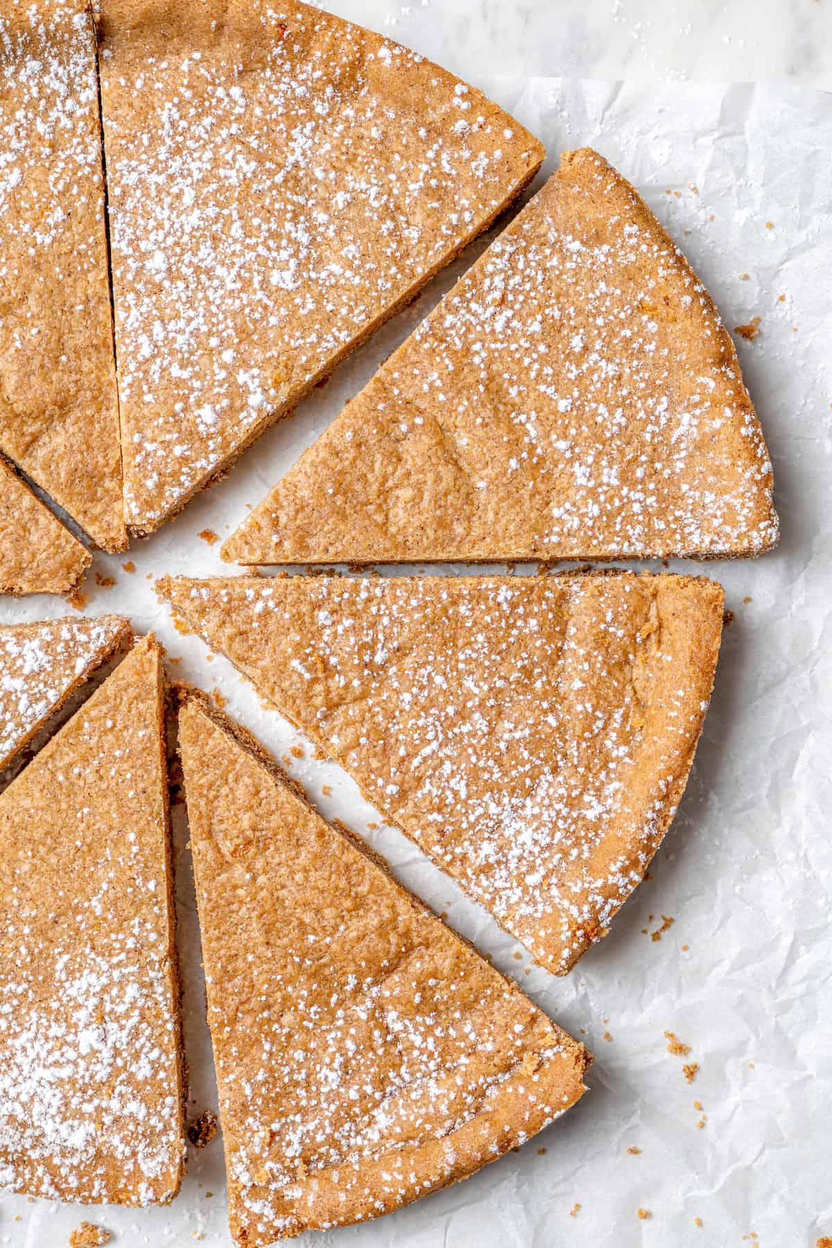 Overhead view of spice cookies cut into wedges and dusted with powdered sugar