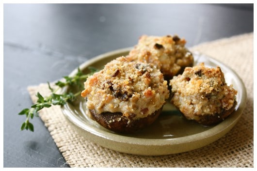 a plate of cheesy stuffed mushrooms