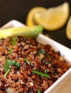 a white bowl of quinoa and black rice salad