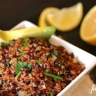 a white bowl of quinoa and black rice salad
