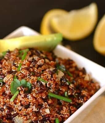 a white bowl of quinoa and black rice salad