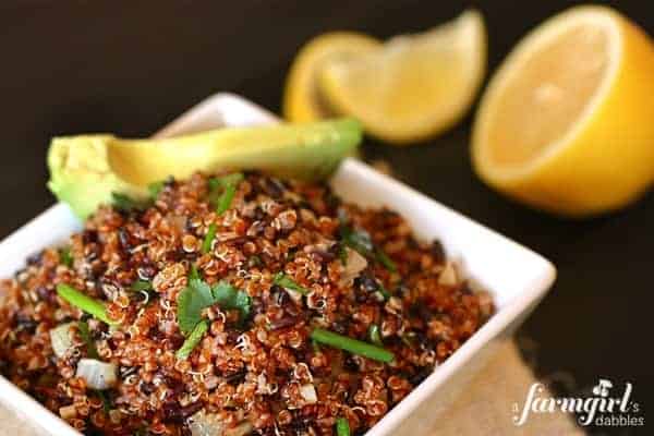 a white bowl of quinoa and black rice salad