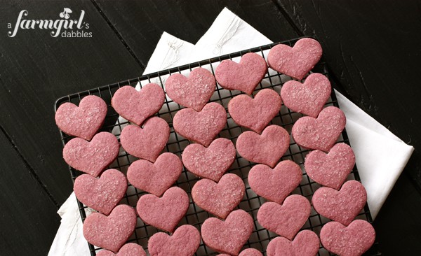 A cooling rack of raspberry shortbread cookies.