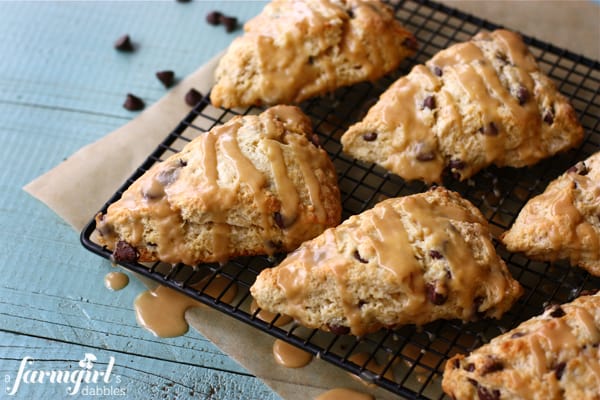 a cooling rack of chocolate chip scones, glazed with peanut butter