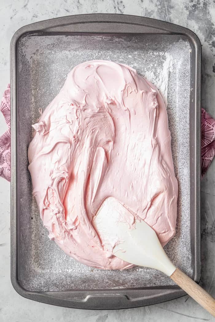 Spreading marshmallow mixture onto pan