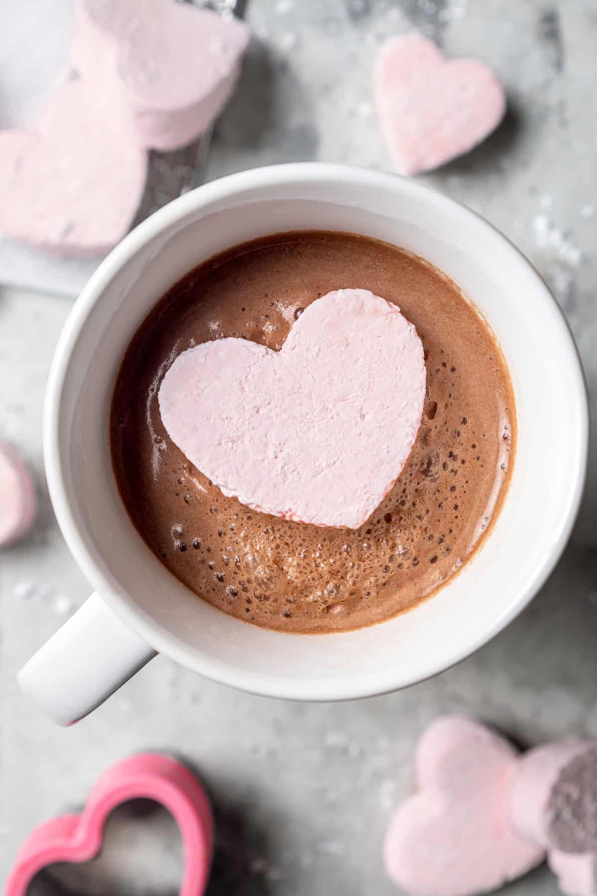 Top-down view of heart marshmallow in mug of hot cocoa