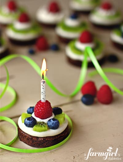 a brownie pie with a lit candle