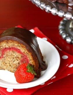 This slice of banana split bundt cake is the perfect dessert - filled with fresh strawberry and topped with rich chocolate.