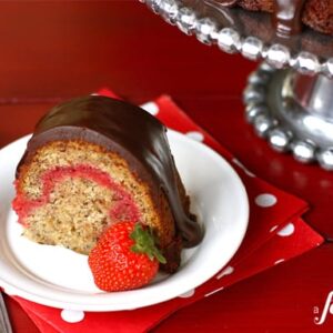 This slice of banana split bundt cake is the perfect dessert - filled with fresh strawberry and topped with rich chocolate.