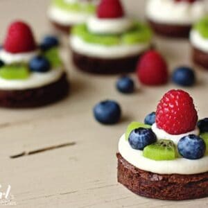 brownie circles topped with almond cream cheese and fresh fruit