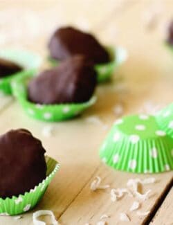 Chocolate dipped coconut marshmallow eggs in a green polka-dot baking cups