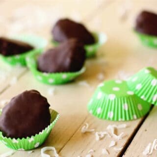 Chocolate dipped coconut marshmallow eggs in a green polka-dot baking cups