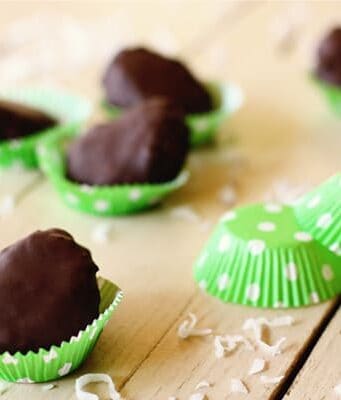 Chocolate dipped coconut marshmallow eggs in a green polka-dot baking cups