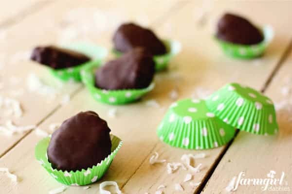 Chocolate dipped coconut marshmallow eggs in a green polka-dot baking cups